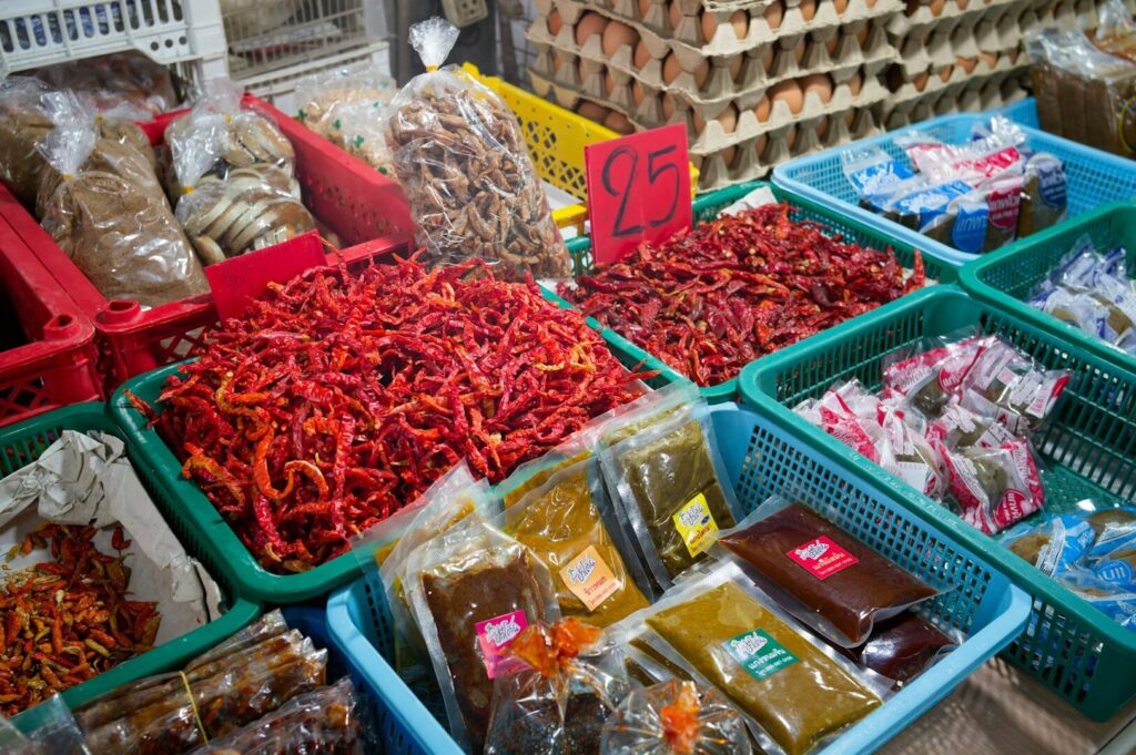 A vibrant Thai local market showcasing a variety of fresh foods and colorful produce.