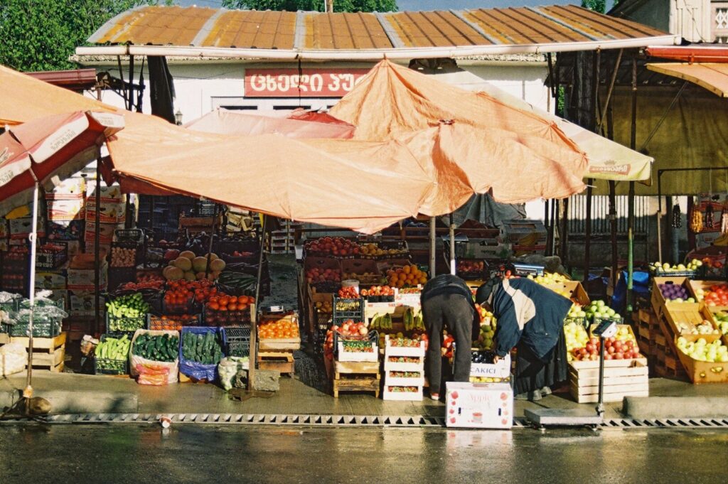A vibrant market filled with fresh produce, showcasing the essence of agritourism and olive-themed trips.