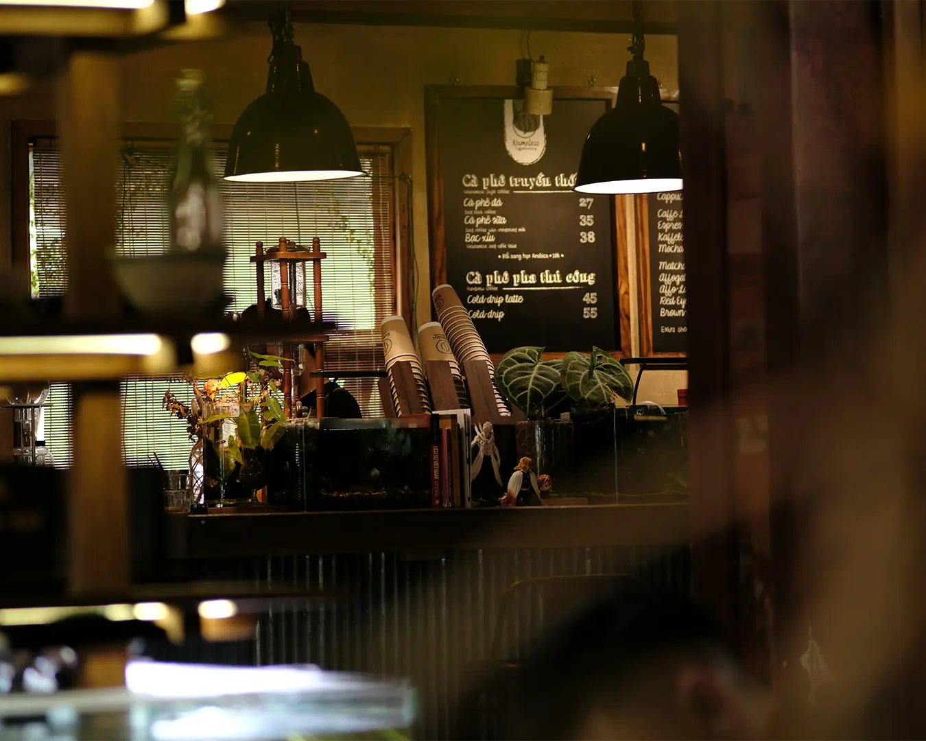 A warm and inviting café interior with soft lighting, comfortable seating, and intimate corners that create a relaxed, homely atmosphere for guests to unwind.